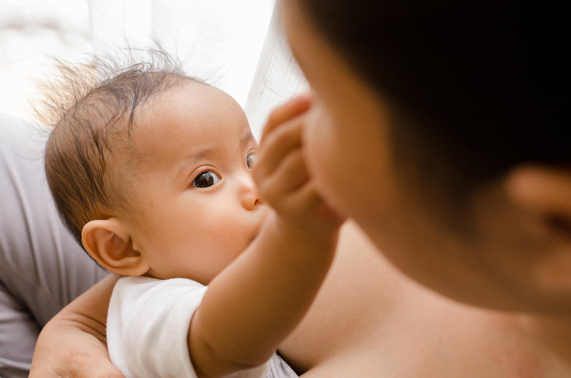 Baby pinching mom's nose