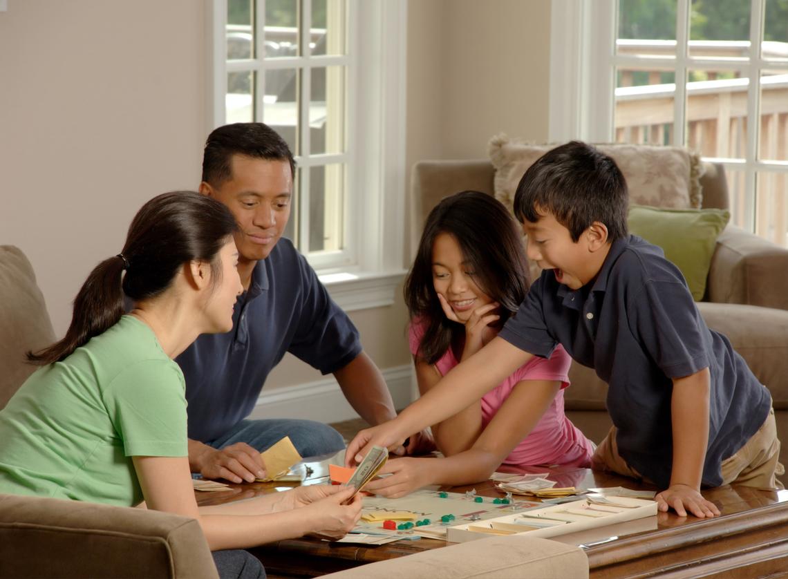 Family playing Monopoly