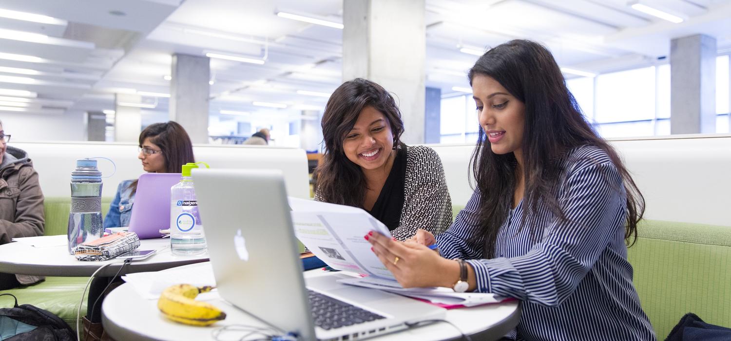 students looking at paper