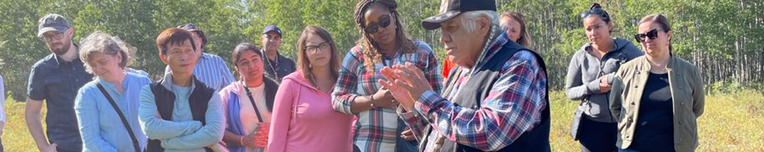 Faculty members on a land walk with an Elder during the faculty retreat on the Tsuut'ina Nation