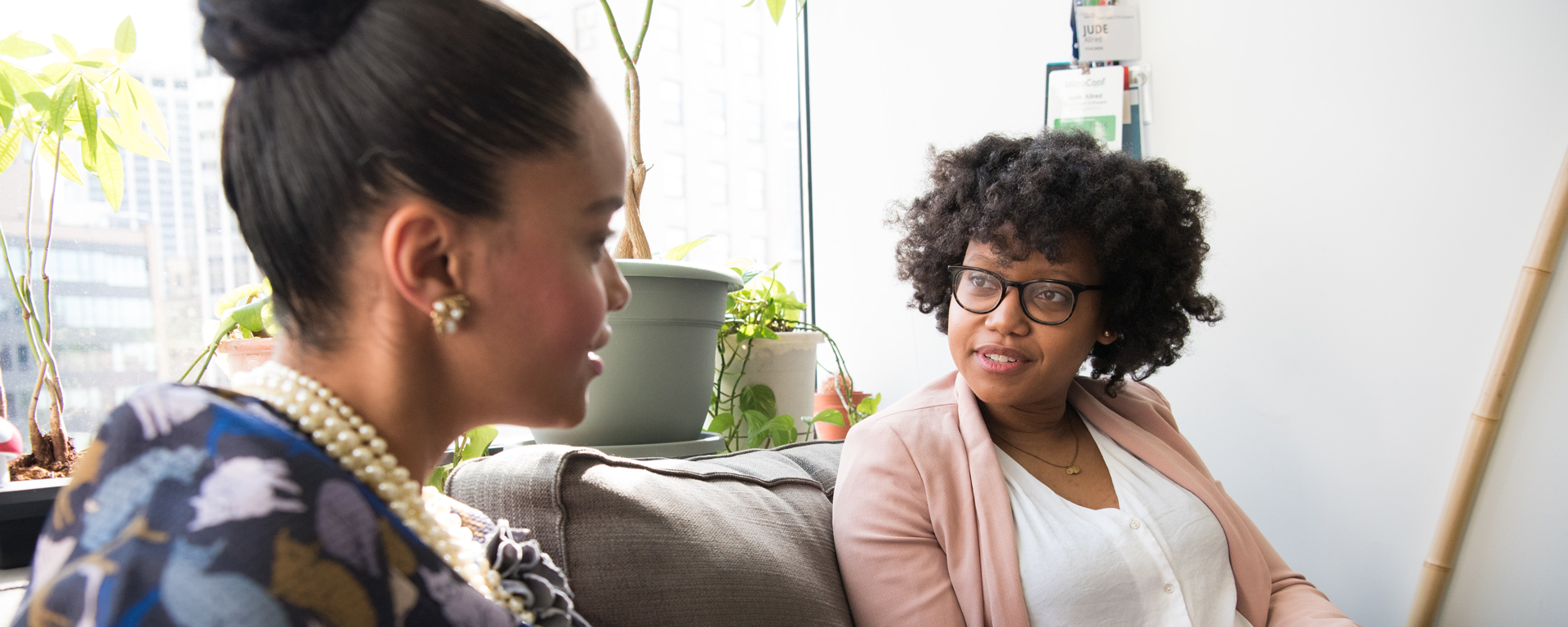 Two women chatting on a couch - University of Calgary Faculty of Social Work Field Education