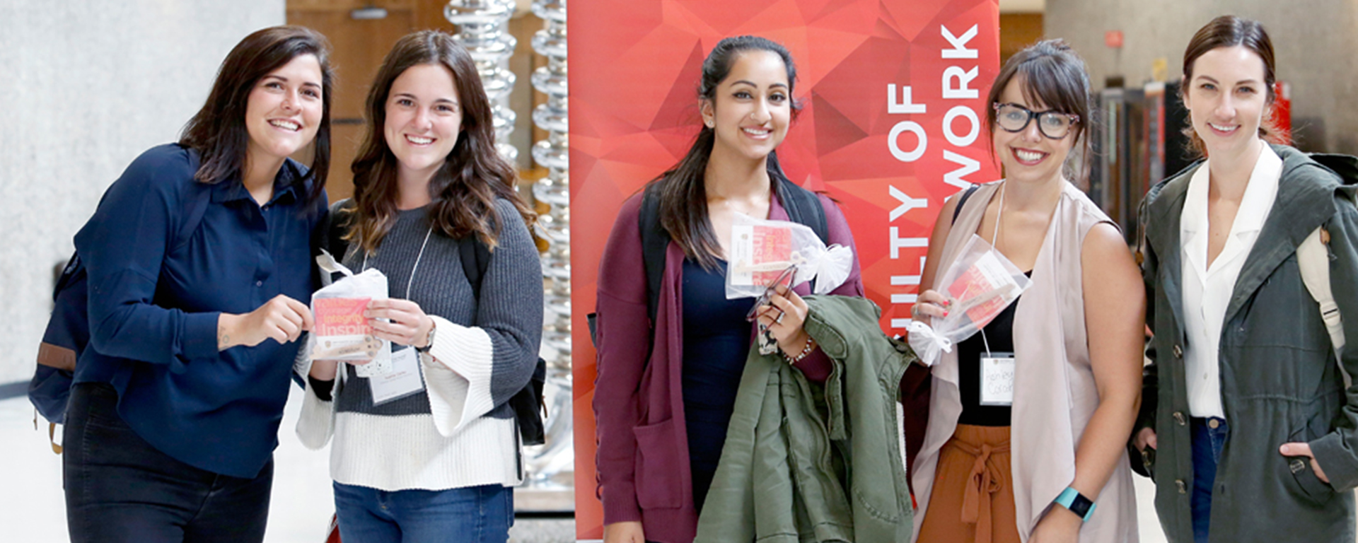 MSW students at our annual orientation, hold wooden keys made by Calgary's Drop-in Centre