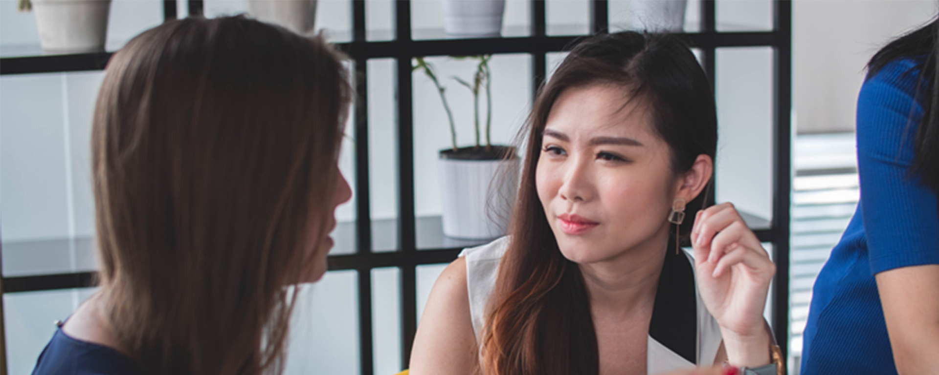 Two women having a professional conversation image promoting the university of Calgary Faculty of Social Work professional Development Programs