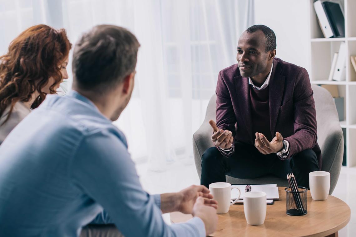 Social work counsellor speaking with couple