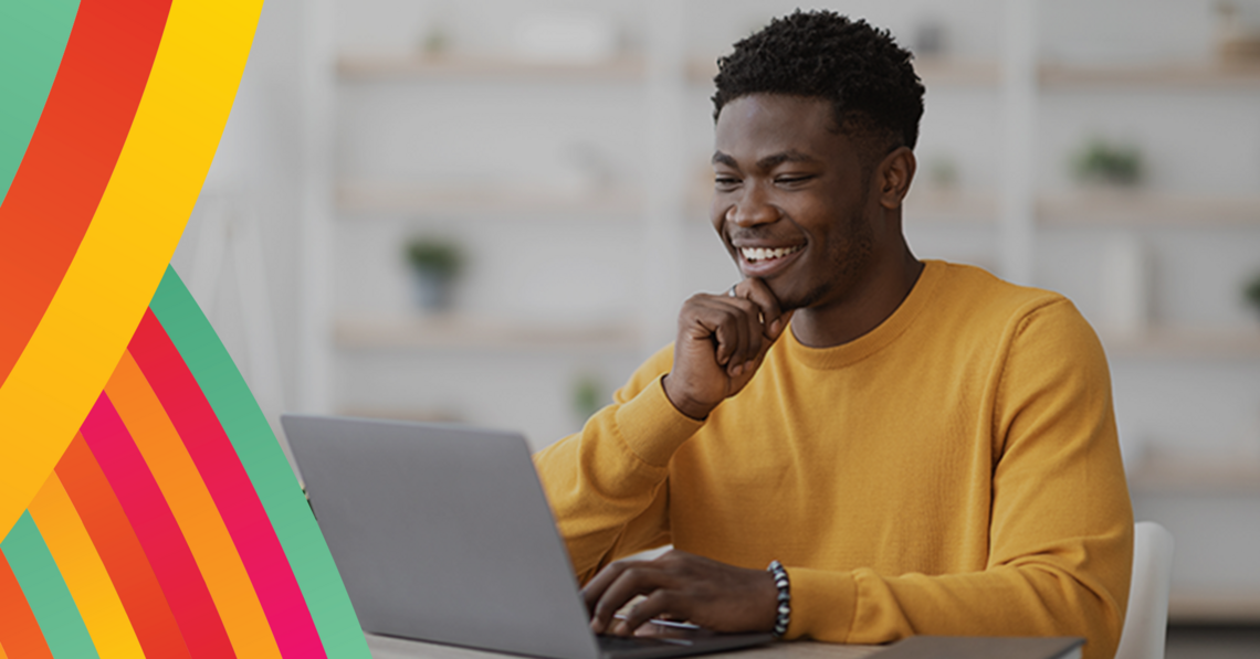 photo of a young man looking at a laptop promoting university of Calgary faculty of social work online Master of social work MSW 