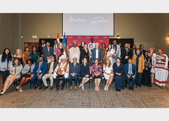 2024 Alberta Immigrant Impact Awards group photo of the award recipients with Elder Charlie Fox, Lieutenant Governor Lakhani, Premier Danielle Smith and Minister Muhammad Yaseen on October 3, 2024.