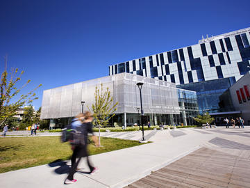 Students walking toward the state-of-the-art Taylor Family Digital Library at the University of Calgary - Faculty of Social Work