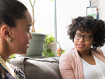 A photo of two women meeting promoting university of Calgary faculty of social work online Master of social work MSW 