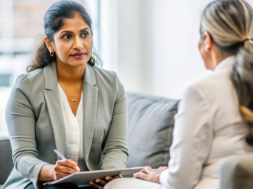 Indian Psychiatrist in Office - Indian female psychiatrist in her office, engaging in a therapeutic session with a patient, demonstrating empathy and professionalism.