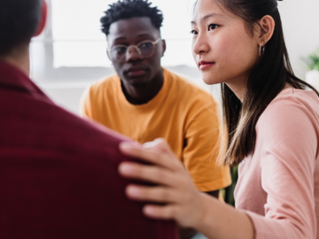 Meeting of young people in group therapy supporting each other at community center. Help and support concept.