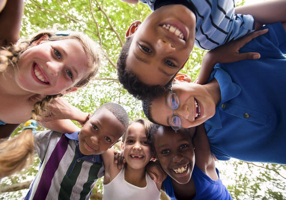 smiling children huddled in a circle