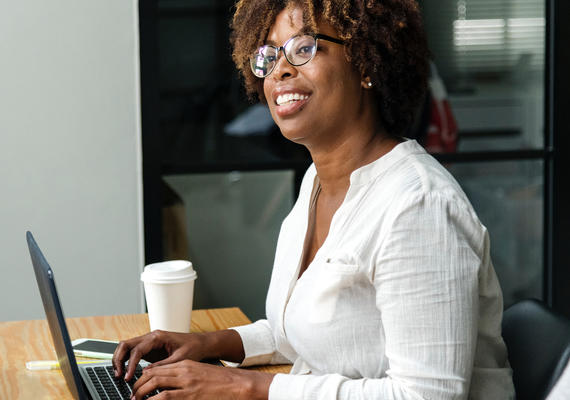 smiling woman working on a laptop