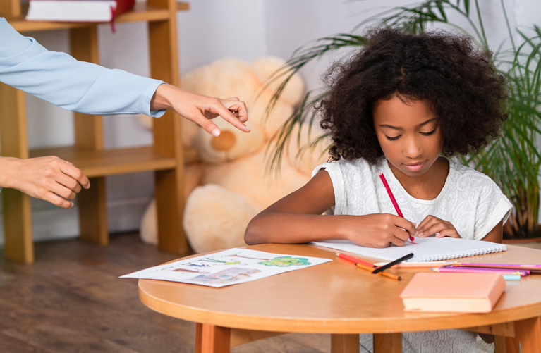  girl drawing with colored pencils